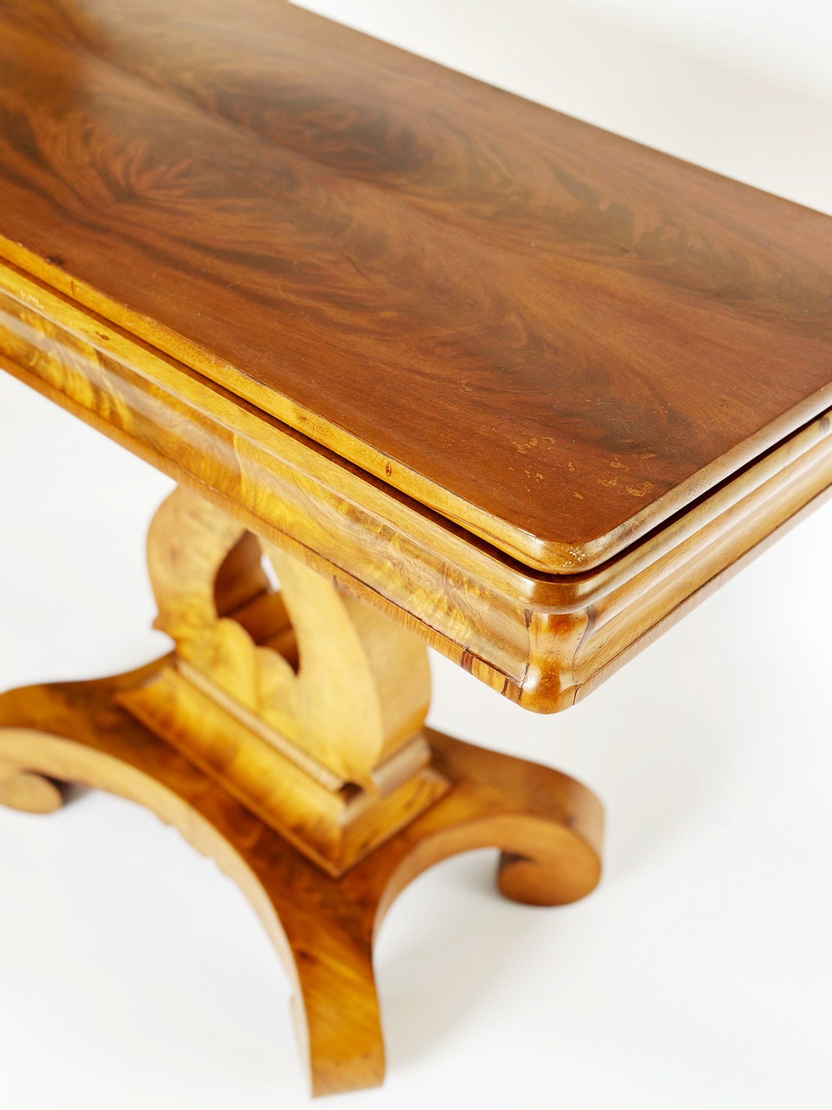 A side view of the top character and patina of the double Burl wood design on the vintage antique Empire game table. This would be a perfect end table or hallway table.