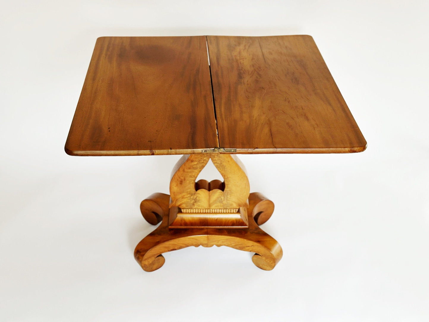 The top of the vintage antique Burl wood Empire end table folds open to make a bigger game table.