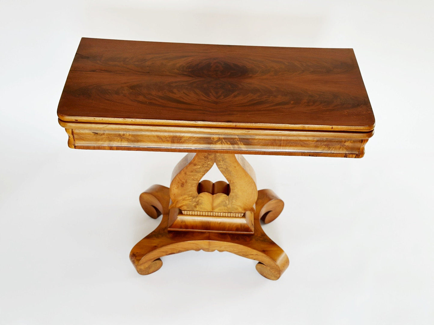 The top of the table vintage antique Empire game end table has a beautiful double burl wood design.