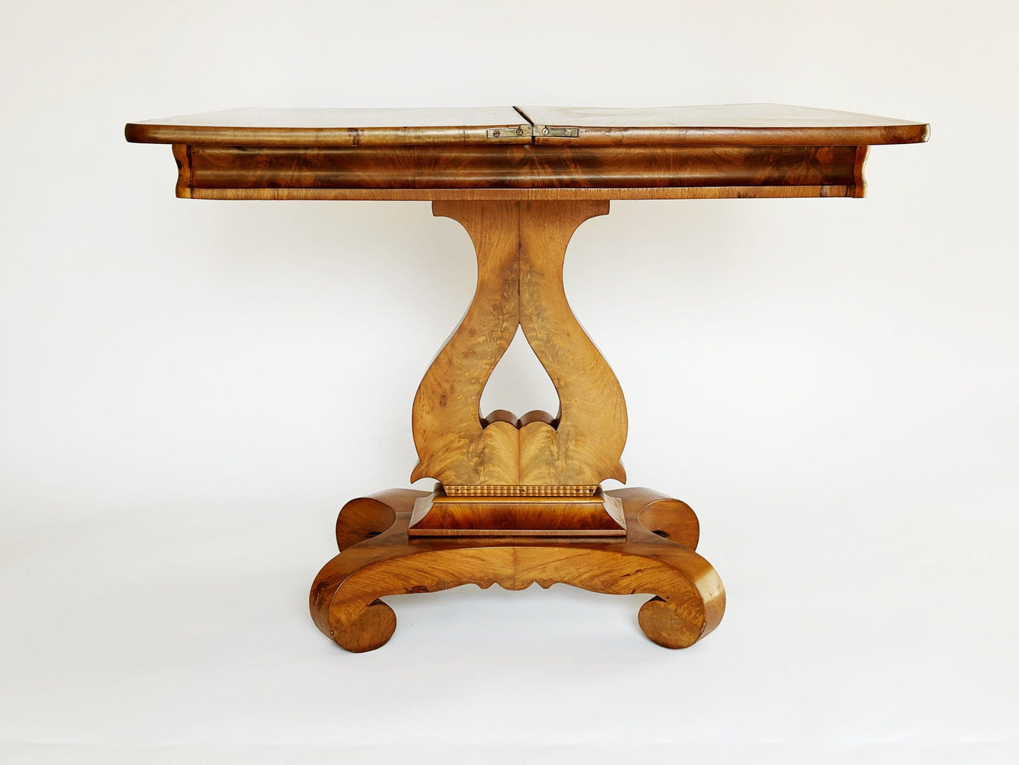 The vintage antique Empire Burl wood table top folds open to double in size and fit more people around to play games and cards. This is a very unique table.