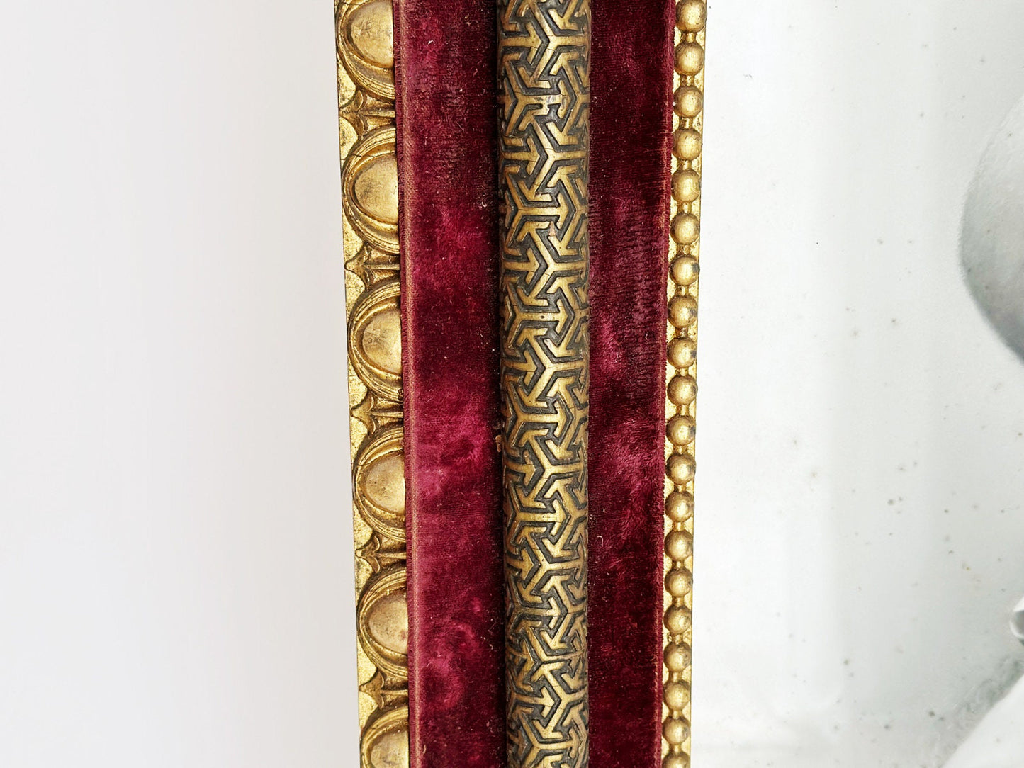Side view of this rare antique Victorian frame showing gorgeous early Art Deco pattern gilt pipe over red velvet. There are beautiful Louis XVI style details on the border.